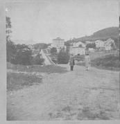 SA0274 - Identified on reverse; looking north, 2 men in road, community behind., Winterthur Shaker Photograph and Post Card Collection 1851 to 1921c